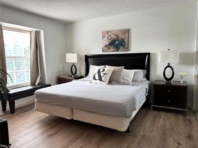 a bedroom with a bed and a large window