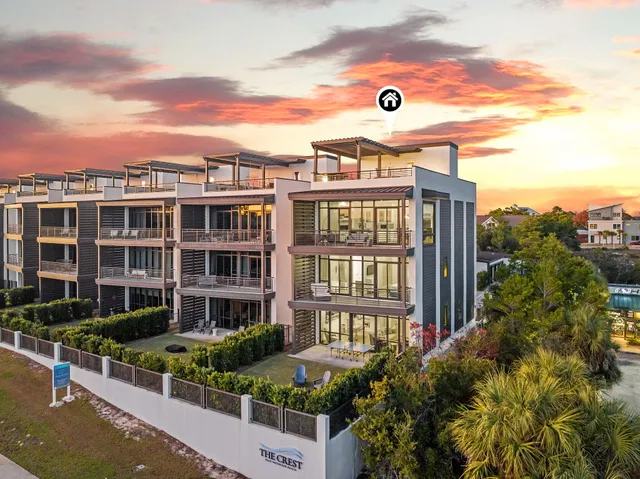 a front view of a residential apartment building with a yard