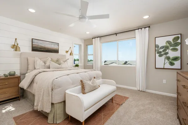a bedroom with a bed and a painting on the wall