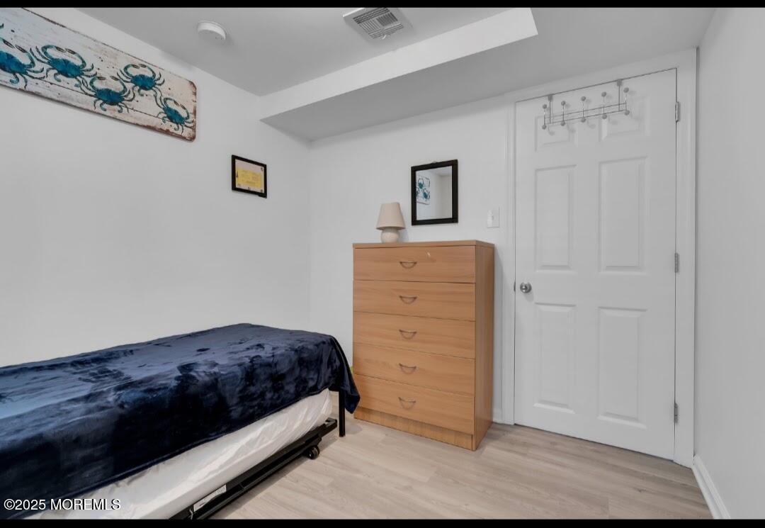 2020 Baltimore Avenue, Unit DOWN Seaside Heights, NJ 08751 - Photo 15 of 18 a bedroom with a bed and a cabinet