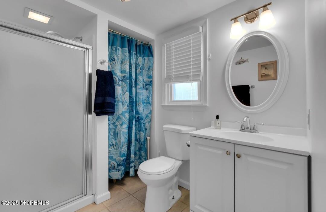 2020 Baltimore Avenue, Unit DOWN Seaside Heights, NJ 08751 - Photo 18 of 18 a bathroom with a toilet sink and mirror