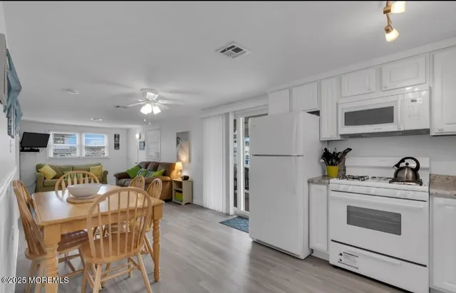 a view of kitchen with furniture and wooden floor