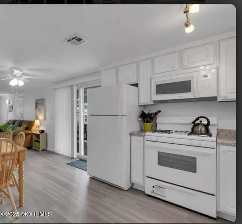 a kitchen with a stove top oven and refrigerator