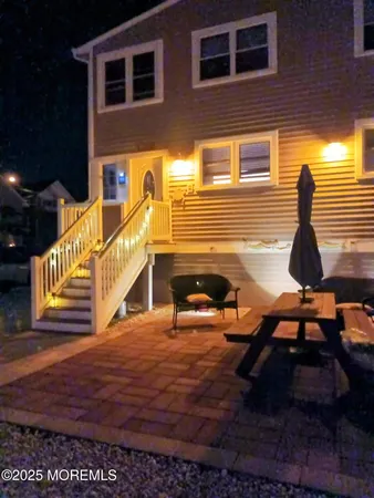 a view of a house with backyard and sitting area