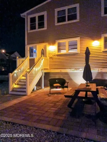 a view of a house with backyard and sitting area