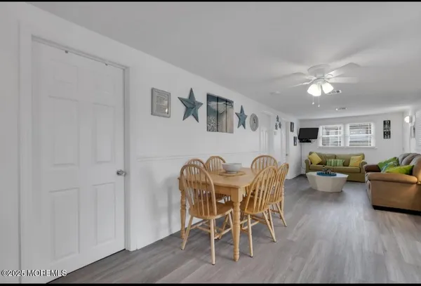 a dining room with furniture and wooden floor