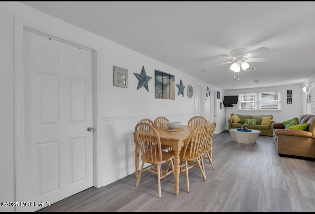 2020 Baltimore Avenue, Unit DOWN Seaside Heights, NJ 08751 - Photo 9 of 18 a dining room with furniture and wooden floor