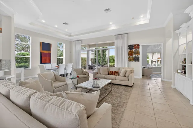 a dining room with furniture and a chandelier