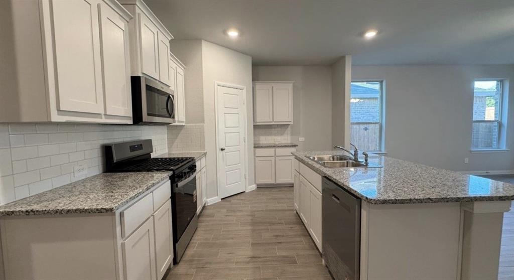 312 Potato Street Keene, TX 76059 - Photo 1 of 21 a kitchen with stainless steel appliances granite countertop a sink stove and refrigerator