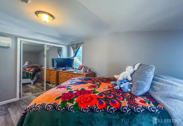 a bedroom with a bed and a chandelier