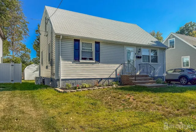 a view of a house with a yard and sitting area