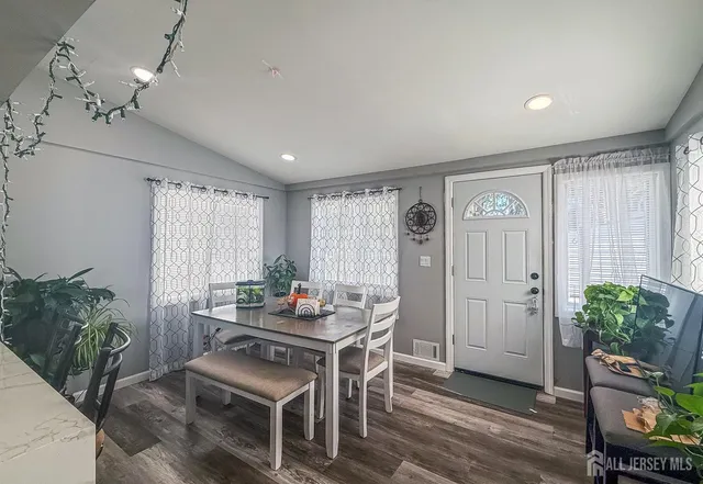 a dining room with furniture and window