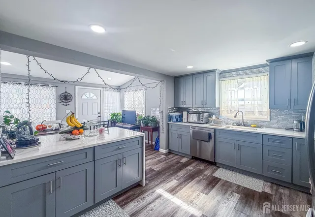 a kitchen with sink a stove and cabinets