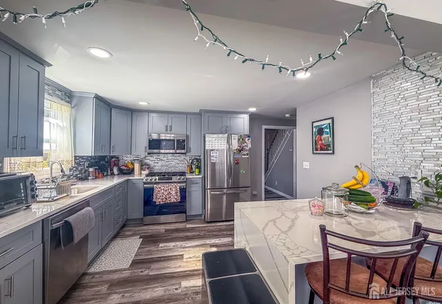 a large kitchen with stainless steel appliances lots of counter top space