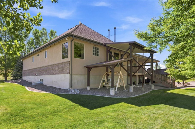 11290 South Southfield Road Mayfield, UT 84643 - Photo 21 of 103 Expansive exterior featuring stucco siding, a brick accent band, a covered upper-level deck, and a lower-level patio