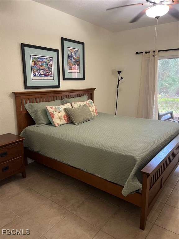 6401 Aragon Way, Unit 107 Fort Myers, FL 33966 - Photo 11 of 28 a bed sitting in a bedroom next to a window