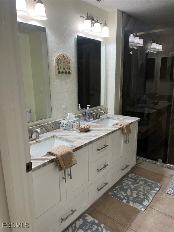 6401 Aragon Way, Unit 107 Fort Myers, FL 33966 - Photo 12 of 28 a bathroom with a sink vanity and a mirror