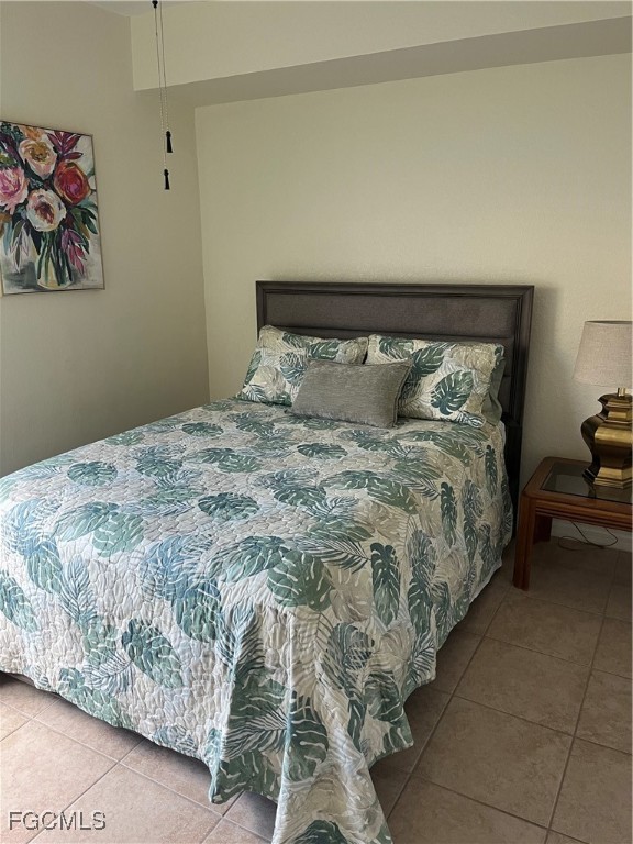 6401 Aragon Way, Unit 107 Fort Myers, FL 33966 - Photo 14 of 28 a large bed sitting in a bedroom next to a cabinet
