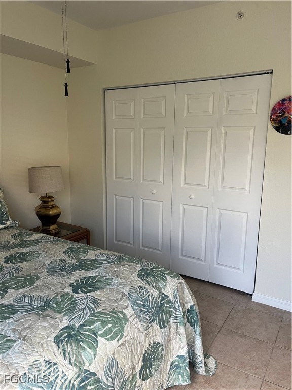 6401 Aragon Way, Unit 107 Fort Myers, FL 33966 - Photo 15 of 28 a bedroom with a bed and a cabinets