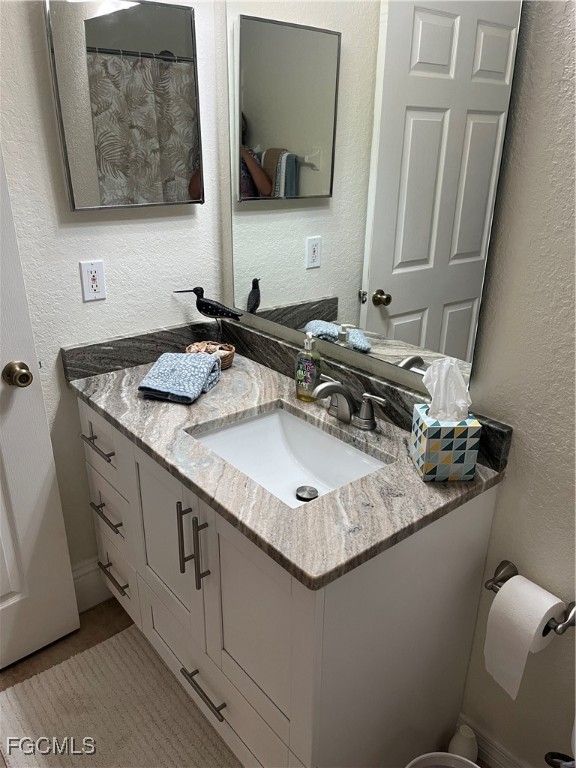 6401 Aragon Way, Unit 107 Fort Myers, FL 33966 - Photo 19 of 28 a bathroom with a sink and a mirror