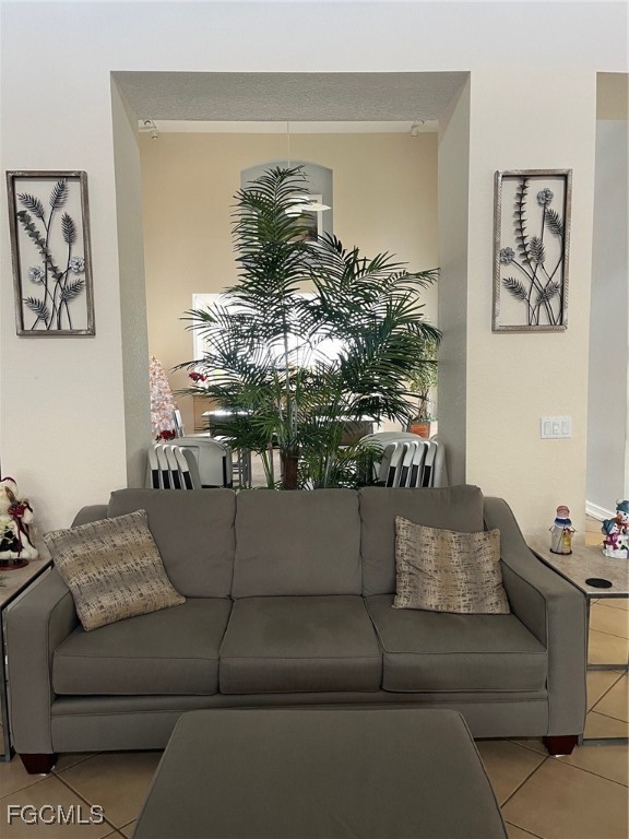 6401 Aragon Way, Unit 107 Fort Myers, FL 33966 - Photo 24 of 28 a living room with furniture and a chandelier