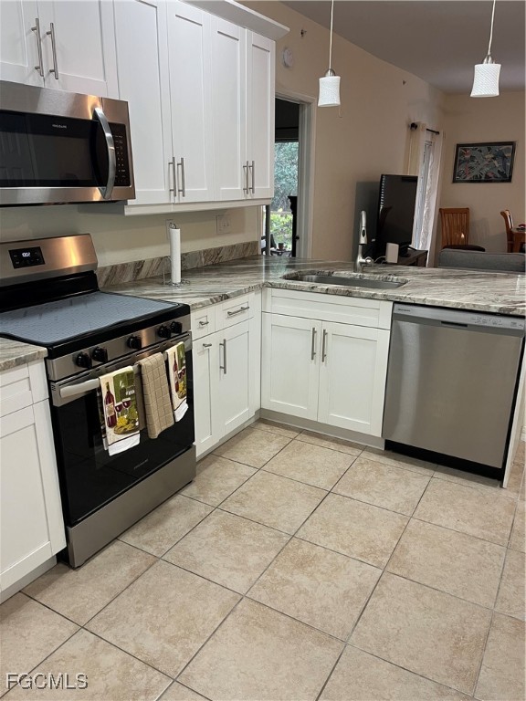 6401 Aragon Way, Unit 107 Fort Myers, FL 33966 - Photo 4 of 28 a kitchen with stainless steel appliances granite countertop a sink stove and cabinets