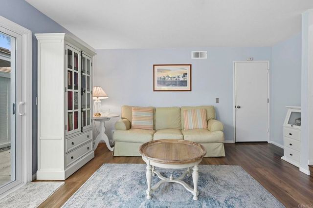 a living room with furniture and a baby crib