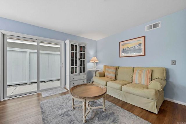 a living room with furniture a rug and a wall painting