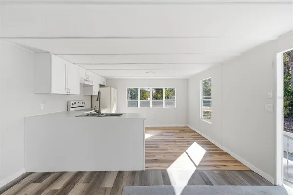 a view of kitchen with wooden floor and window