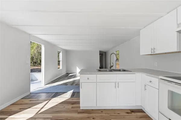 a kitchen with sink and cabinets