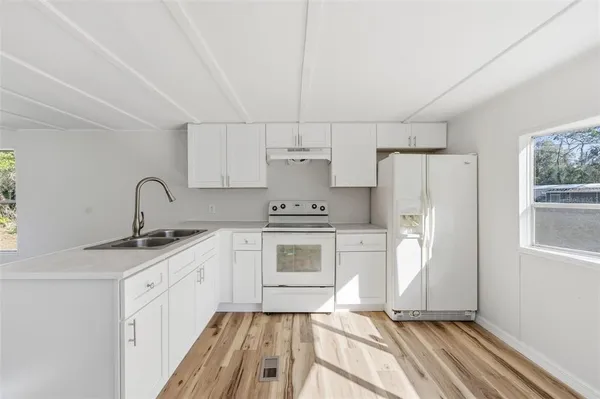 a kitchen with a sink cabinets and stainless steel appliances