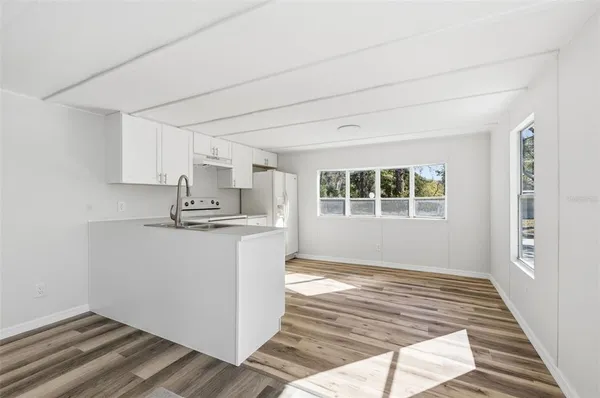 a view of kitchen and wooden floor