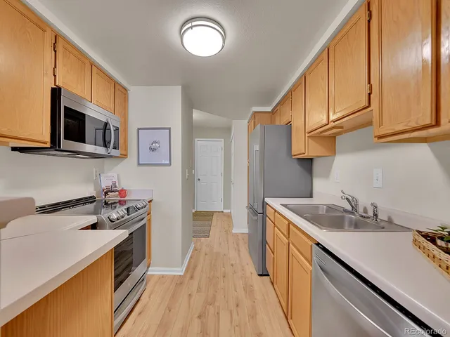 a kitchen with a sink stove top oven and microwave