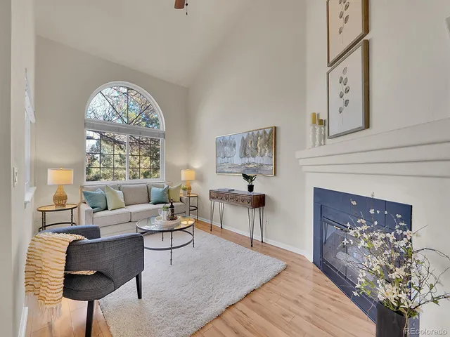 a living room with furniture a fireplace and a chandelier