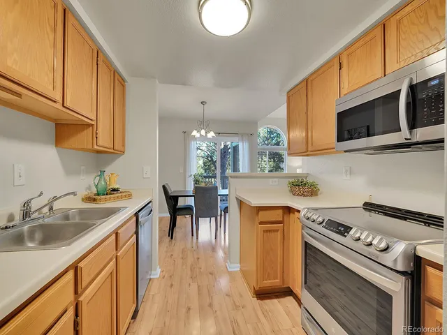 a kitchen with stainless steel appliances a sink stove and cabinets