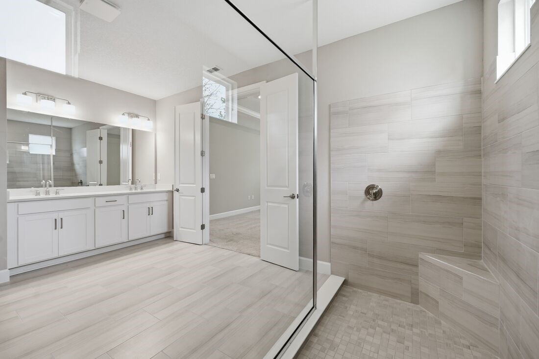 86049 Living Waters Run Yulee, FL 32097 - Photo 17 of 36 a bathroom with a double vanity sink toilet and shower