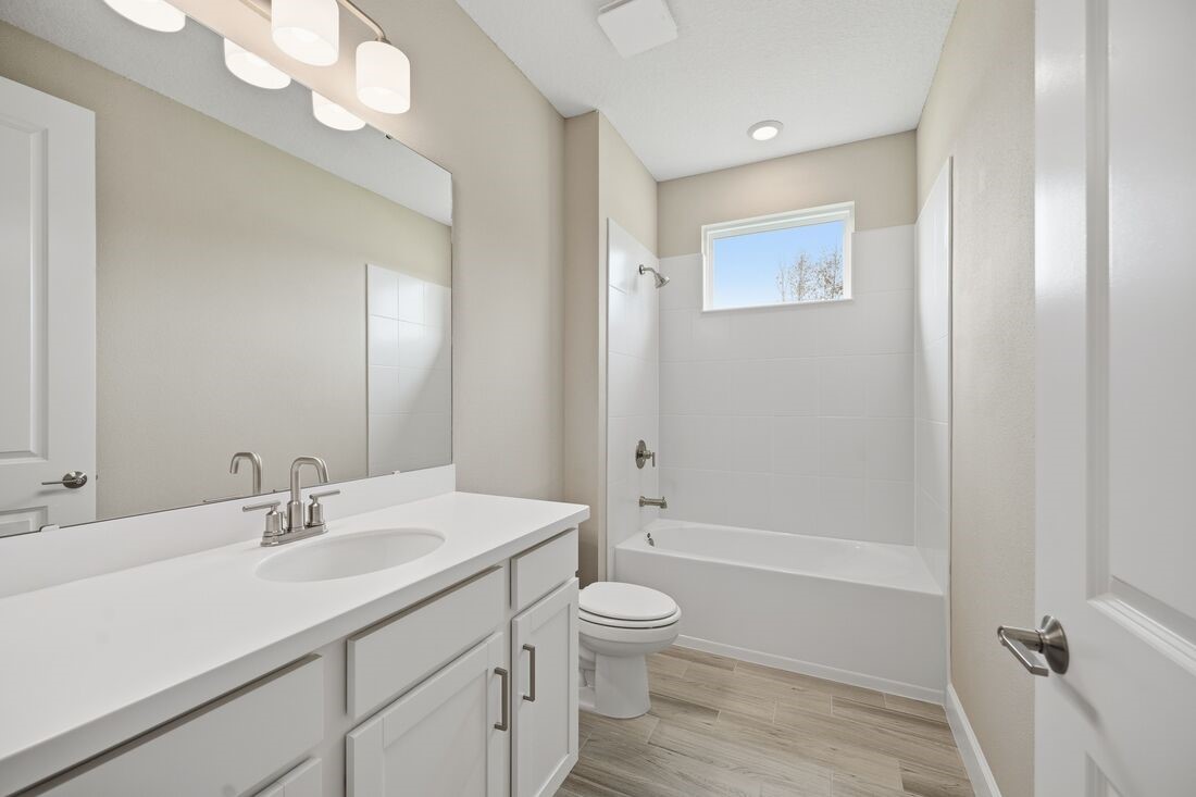 86049 Living Waters Run Yulee, FL 32097 - Photo 29 of 36 a bathroom with a granite countertop sink toilet a large mirror a shower and a bathtub