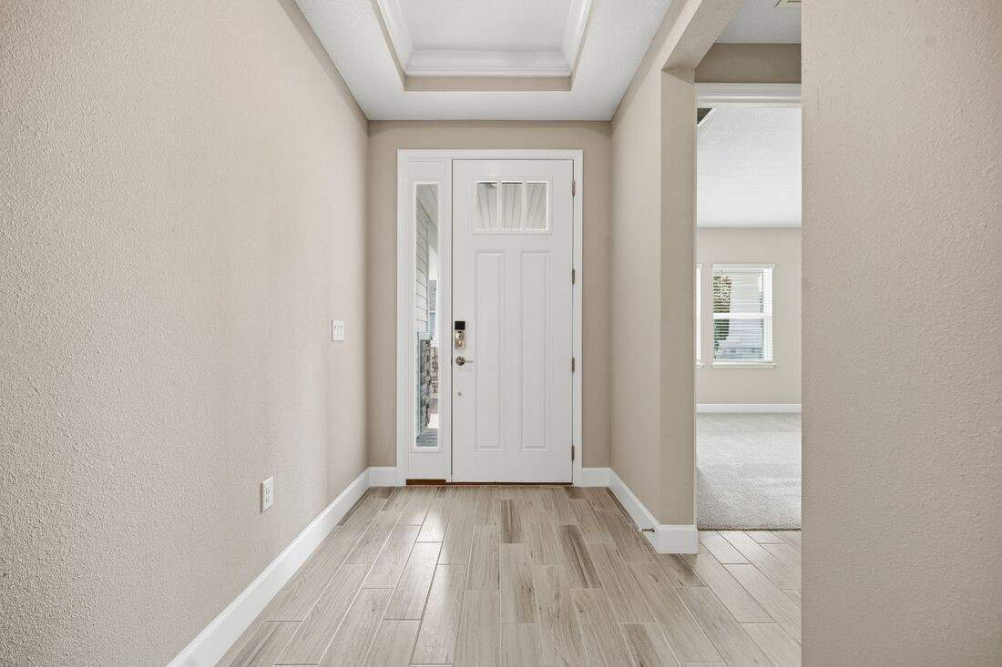 86049 Living Waters Run Yulee, FL 32097 - Photo 32 of 36 an empty room with wooden floor and mirror