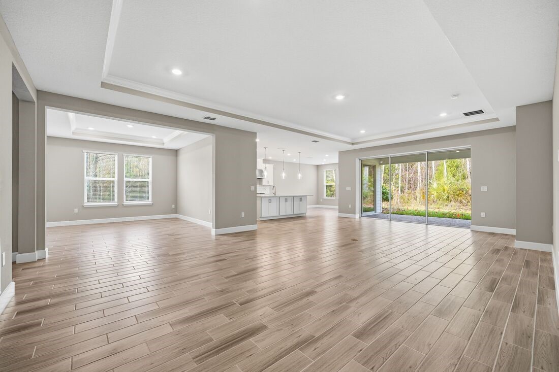 86049 Living Waters Run Yulee, FL 32097 - Photo 9 of 36 a view of an empty room with wooden floor and a window
