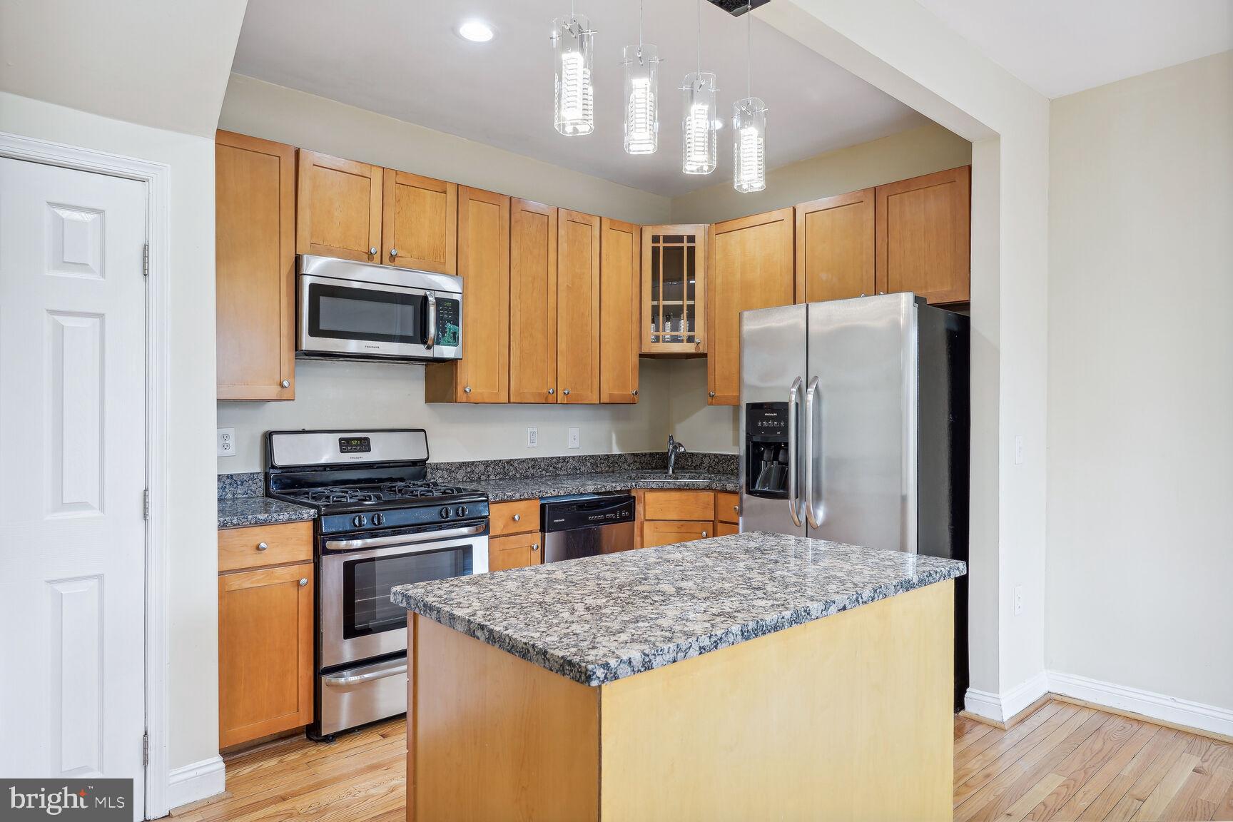 4528 4th Street Northwest Washington, DC 20011 - Photo 8 of 28 a kitchen with stainless steel appliances granite countertop a refrigerator stove microwave and sink