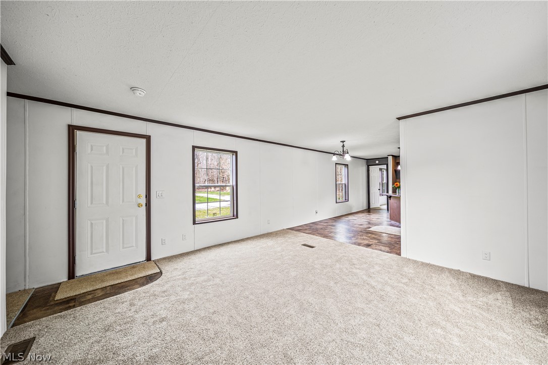 3651 Austin Road, Unit N28 Geneva, OH 44041 - Photo 16 of 30 Entryway with a textured ceiling, hardwood / wood-style floors, and ornamental molding