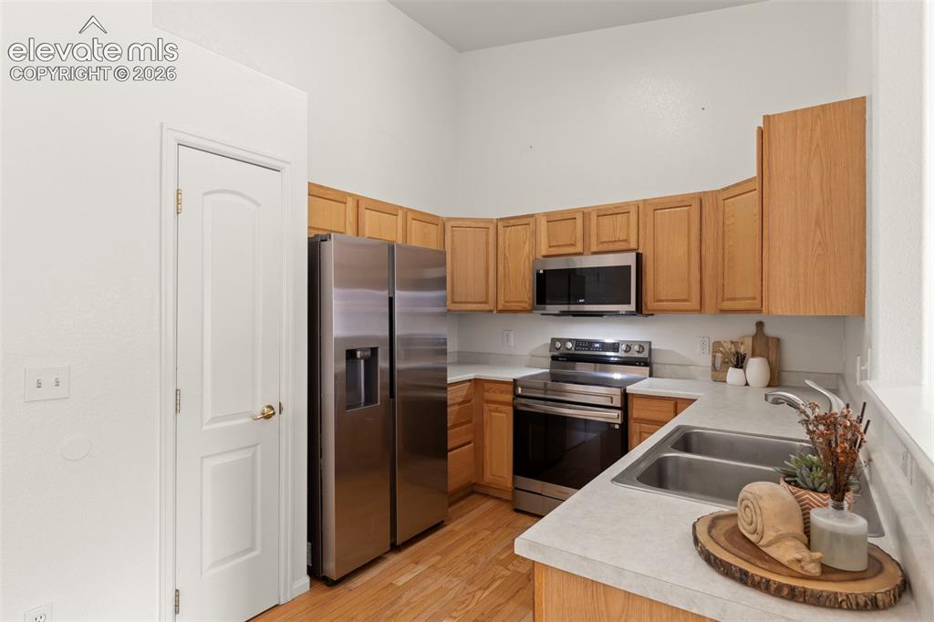 1563 Monterey Road, Unit D Colorado Springs, CO 80910 - Photo 4 of 22 a kitchen with stainless steel appliances granite countertop a refrigerator a stove and a sink