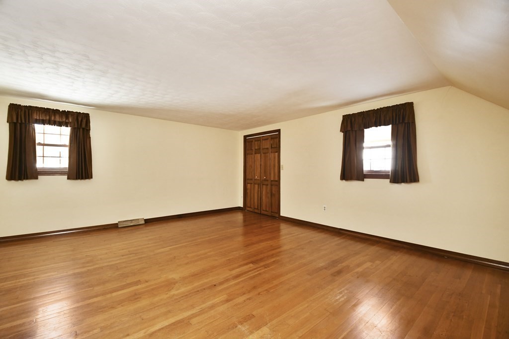 72 Old Bolton Road Hudson, MA 01749 - Photo 20 of 42 a view of an empty room with wooden floor and a window