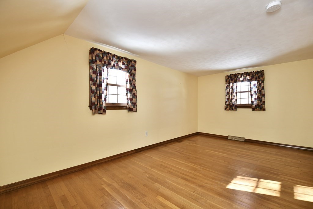 72 Old Bolton Road Hudson, MA 01749 - Photo 22 of 42 an empty room with wooden floor and windows