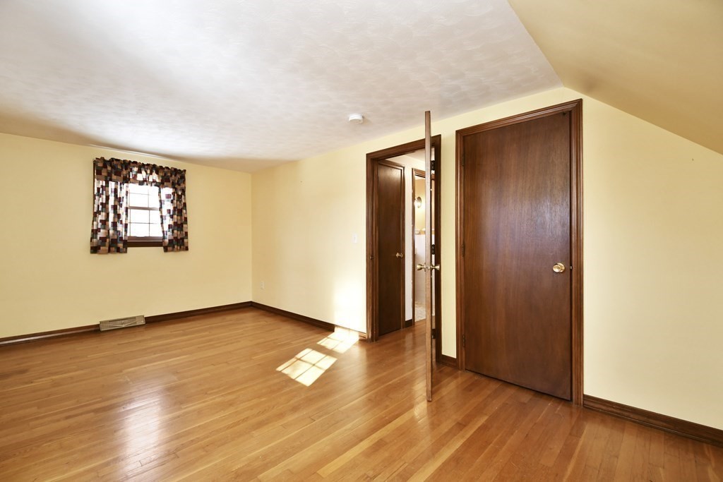 72 Old Bolton Road Hudson, MA 01749 - Photo 23 of 42 an empty room with wooden floor and windows