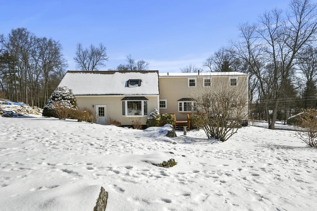 72 Old Bolton Road Hudson, MA 01749 - Photo 30 of 42 a view of a house with a yard covered in snow
