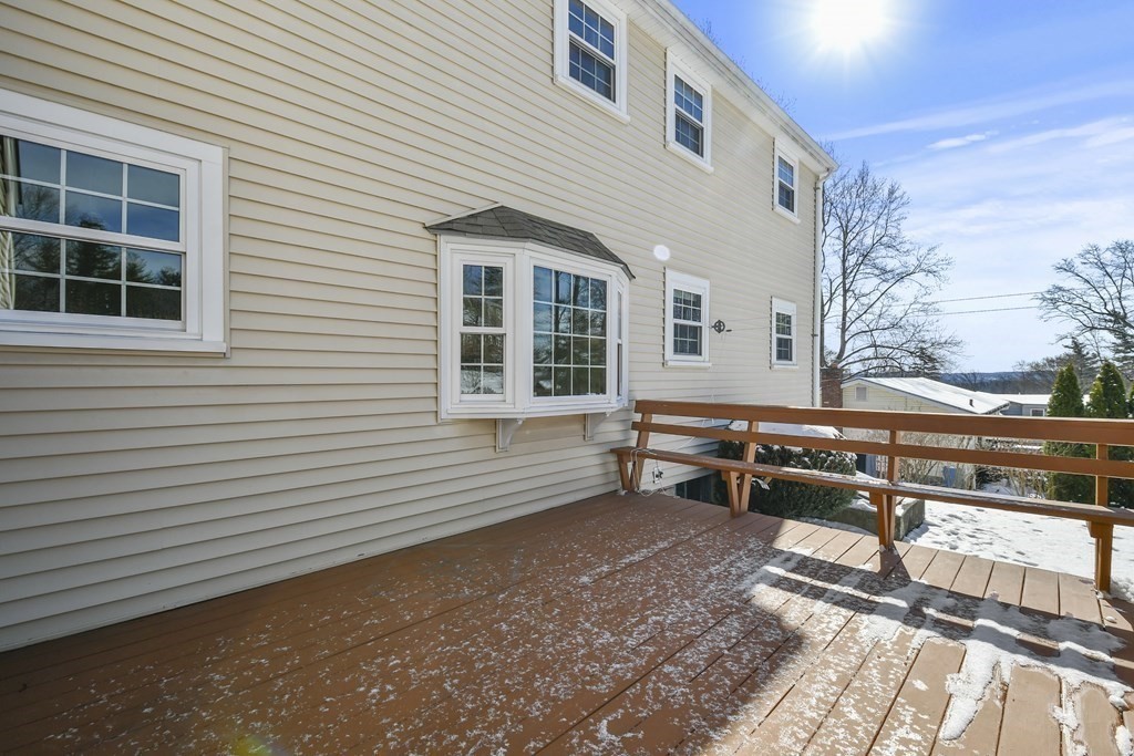 72 Old Bolton Road Hudson, MA 01749 - Photo 32 of 42 a backyard of a house with wooden fence and a tree