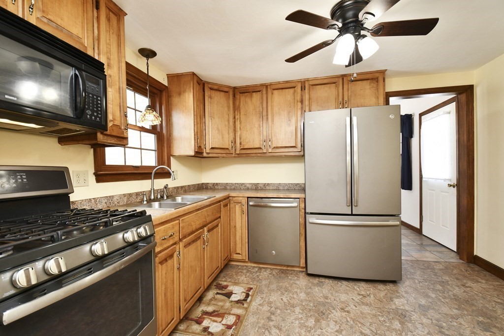 72 Old Bolton Road Hudson, MA 01749 - Photo 5 of 42 a kitchen with stainless steel appliances a refrigerator a stove a sink and a microwave