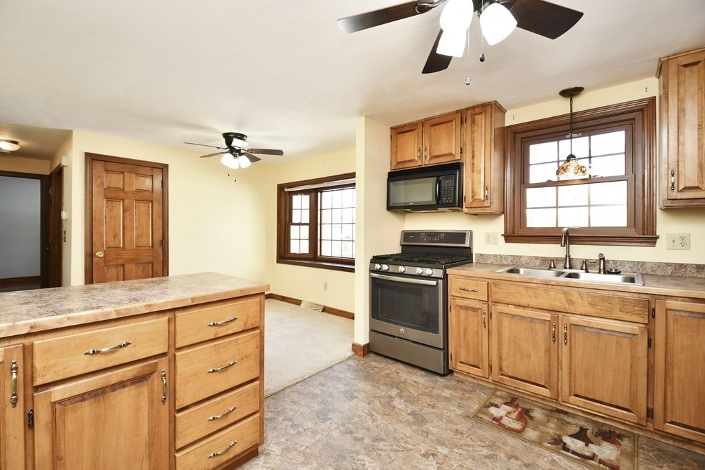 72 Old Bolton Road Hudson, MA 01749 - Photo 6 of 42 a kitchen with stainless steel appliances granite countertop a stove a sink and a microwave