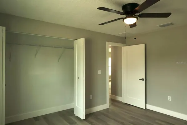 a view of an empty room and wooden floor